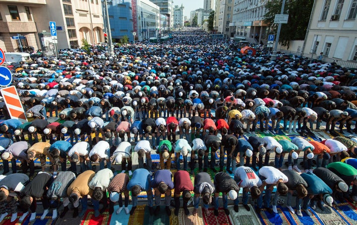 Russian Muslims pray outside the central mosque in Moscow on July 17, 2015, during celebrations of Eid al-Fitr marking the en