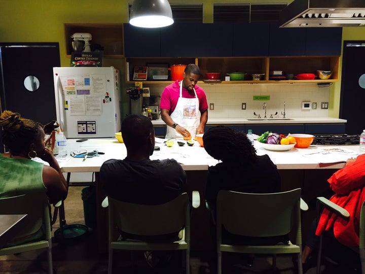 Participants look on while a community volunteer conducts a cooking class as part of Oldways' African Heritage and Health program.