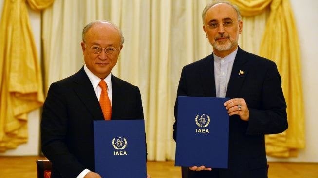 IAEA Director General Yukiya Amano and Vice President of the Islamic Republic of Iran Ali Akhbar Salehi sign a roadmap for the clarification of past and present issues regarding Iran's nuclear program in Vienna.