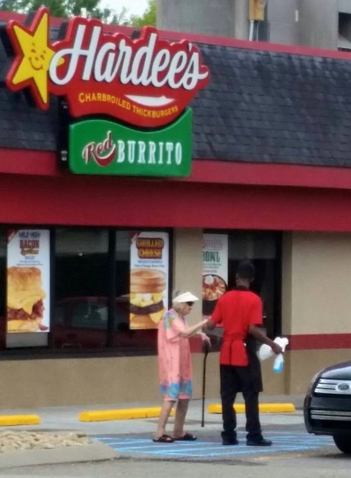 Photo of Kailen Young helping Bobbi Clare to her car, which went viral. 