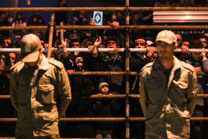 
Iranian women pray as a man is brought to the gallows during his execution ceremony in the northern city of Noor in 20