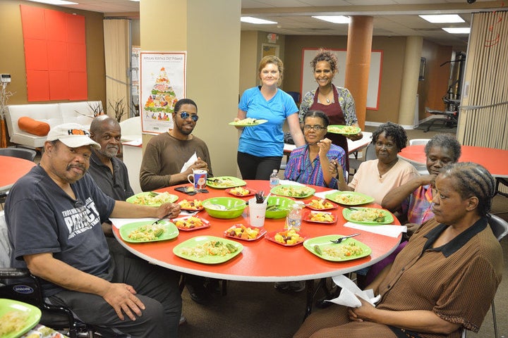 Participants in an Oldways' African Heritage and Health cooking class prepare to dine on a dish they prepared.