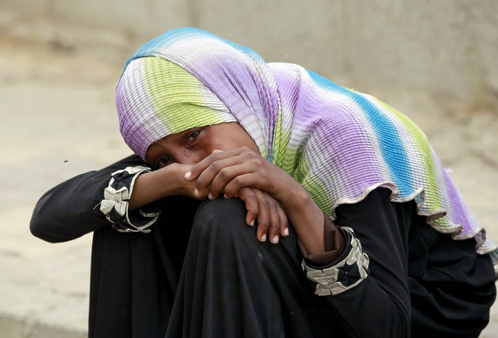 A Yemeni woman cries over the death of relatives in a reported airstrike by the Saudi-led coalition on the capital Sanaa on July 13, 2015. 