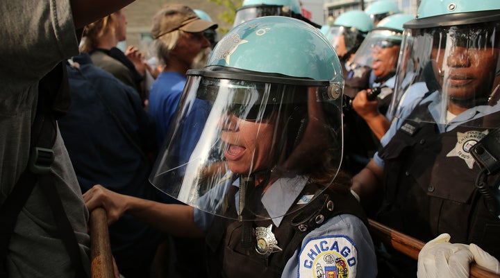 <span>Protesters and Chicago Police confront each other near the NATO conference venue on the first day of the NATO summit on