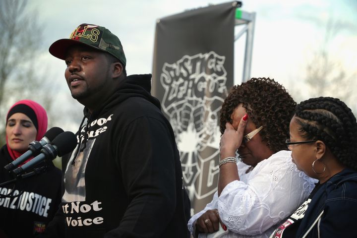 Martinez Sutton (2nd L) speaks about the shooting death of his sister Rekia Boyd by Chicago police detective Dante Servin as his mother Angela Helton (3rd L) covers up her face during a rally to mark the finishing of March2Justice April 21, 2015 at the West Lawn of the U.S. Capitol in Washington, DC.