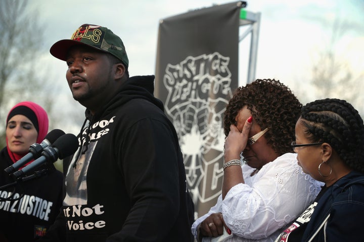 Martinez Sutton (2nd L) speaks about the shooting death of his sister Rekia Boyd by Chicago police detective Dante Servin as his mother Angela Helton (3rd L) covers up her face during a rally to mark the finishing of March2Justice April 21, 2015 at the West Lawn of the U.S. Capitol in Washington, DC.