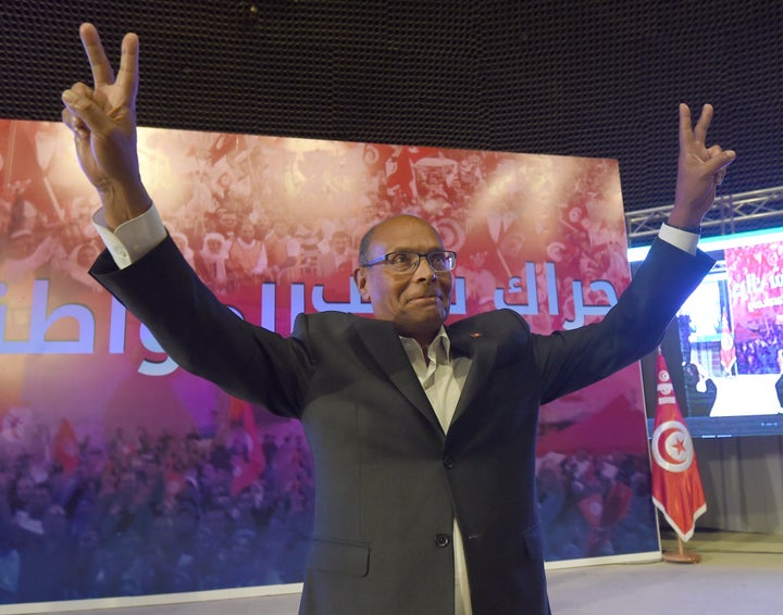 Former Tunisian President Moncef Marzouki flashes the sign for victory during a preparatory congress ahead of launching his new movement, called Harak Chaab al Mouatinine (Citizen People Movement) in Tunis, on April 25, 2015, four months after he lost a reelection bid.