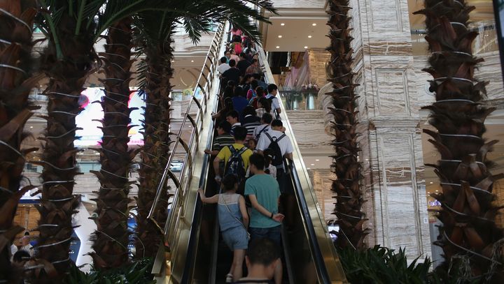 People ride up an escalator at the New Century Global Center on June 30, 2015, in Chengdu, China.