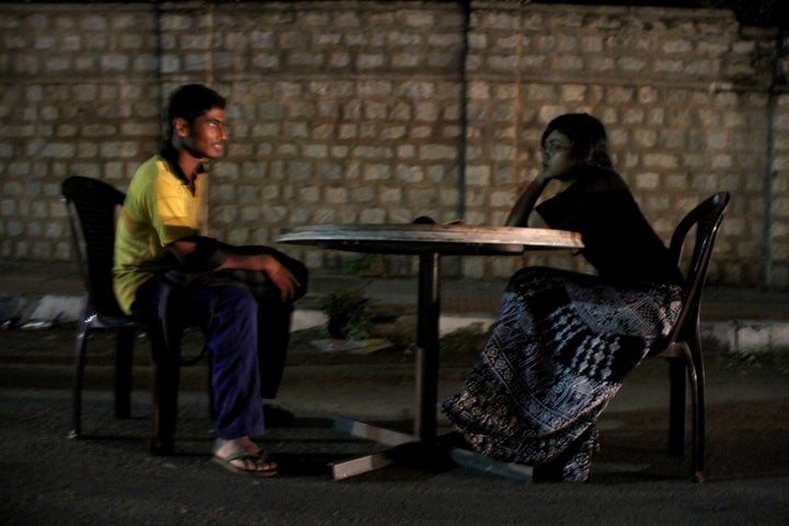 <p><em>An activist converses with a stranger on a road near Bangalore, India, as part of the award-winning public art project, "Talk To Me." </em></p>