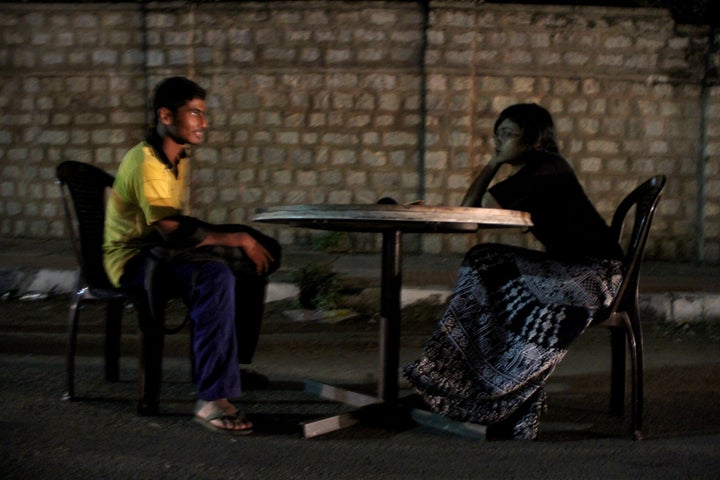 An activist converses with a stranger on a road near Bangalore, India, as part of the award-winning public art project, "Talk To Me." 