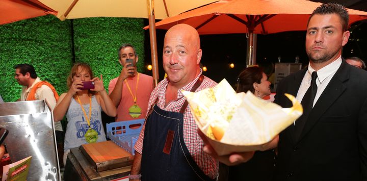Food writer Andrew Zimmern, left, with someone who probably hasn't tried donkey before.