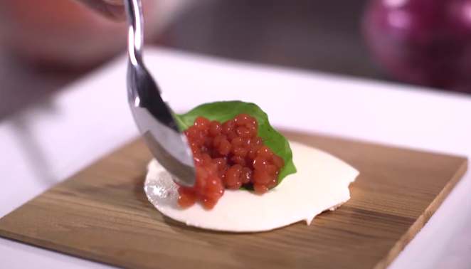 <p>Tomato pearls on fresh mozzarella. </p>