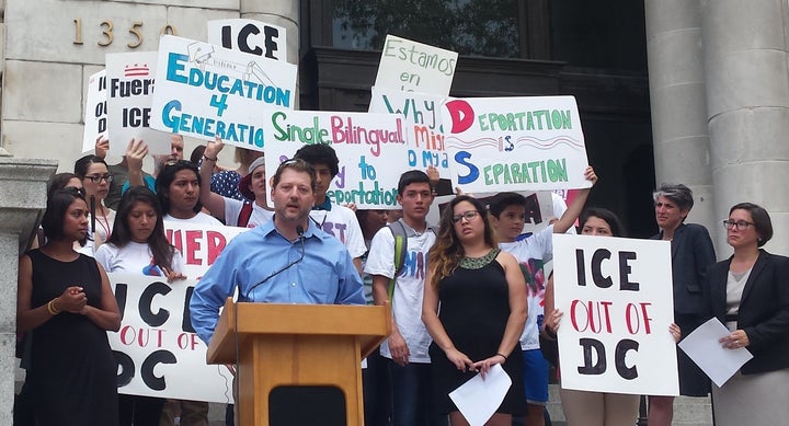 D.C. Councilmember-At-Large David Grosso (I) speaks with immigration activists on the steps of the John A. Wilson Building, July 30, 2015.