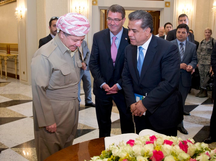 Kurdistan Regional Government President Massoud Barzani (L), U.S. Defense Secretary Ash Carter (C), and Falah Mustafa, Kurdistan's foreign minister, stand together by a guest bookon July 24, 2015 in Erbil, Iraq. (Photo by Carolyn Kaster - Pool/Getty Images)