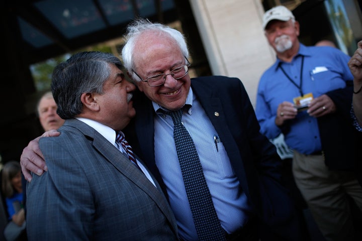 <p>AFL-CIO president Richard Trumka (L) and Sanders (R) share a moment at an April rally. Sanders' skepticism of guest worker programs is shared by organized labor with which he has close ties. </p>