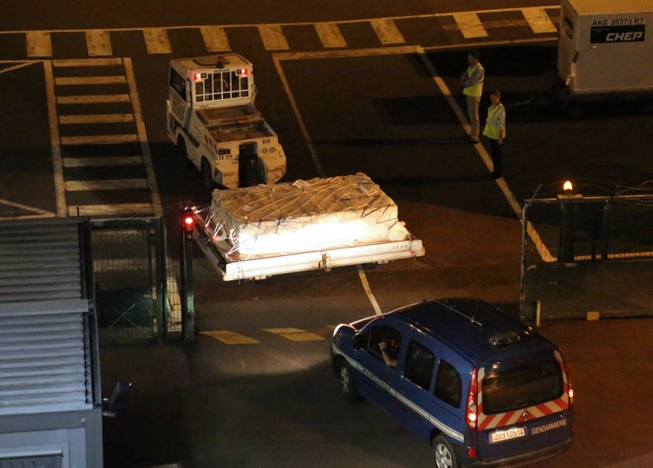 <span> Police officers escort an airport vehicle transporting what is believed to be debris from a Boeing 777 plane that