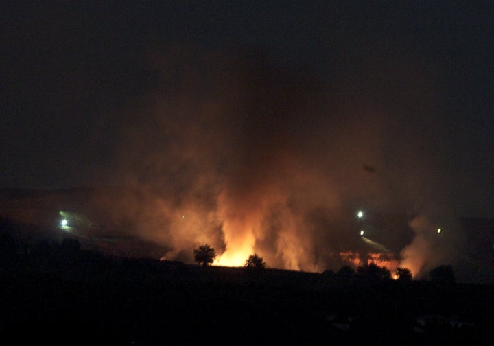 Flames are seen from Turkey's Gaziantep province after ISIS opened fire on the PYD-controlled village of Zormagara from the city of Jarabulus near Aleppo on July 31, 2015.