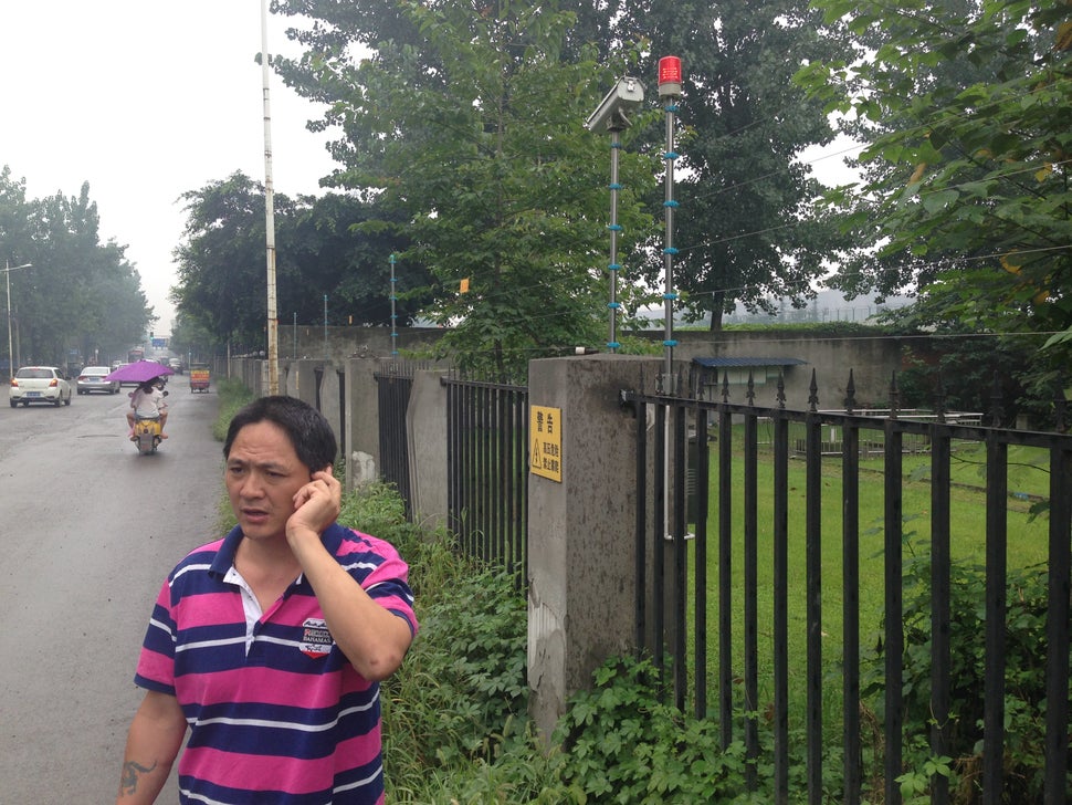 Liu Zhizhong searches his wife, Li Ming, outside a prison on July 20th. Li was detained on July 18th and remains in cust