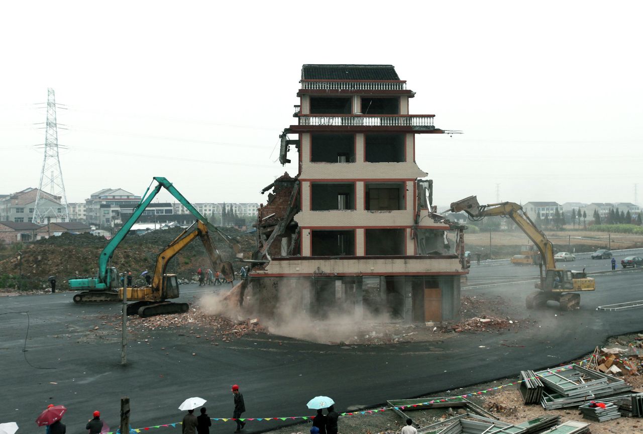 <p>A "nail house" in the middle of a road in central China is finally demolished in 2012.</p>