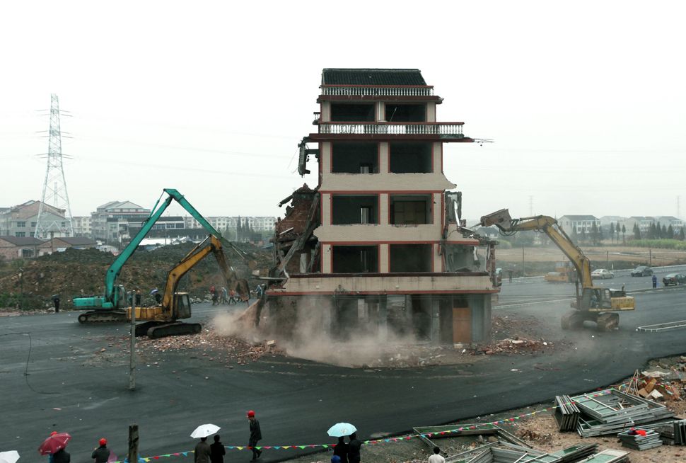 A "nail house" in the middle of a road in central China is finally demolished in 2012.