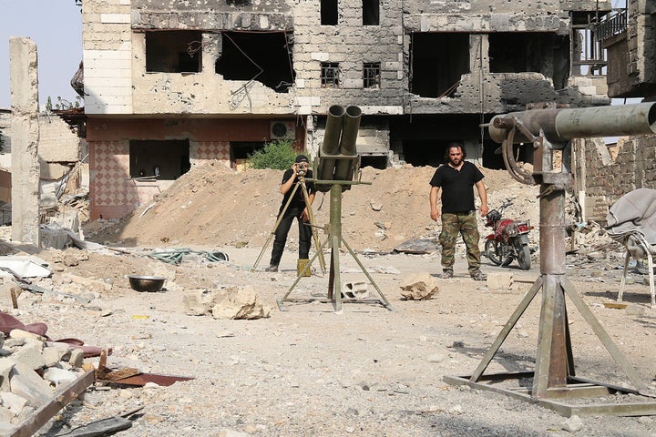 
Members of Free Syrian Army of Syrian opposition make preparations before they stage an operation on Assad's regime fo
