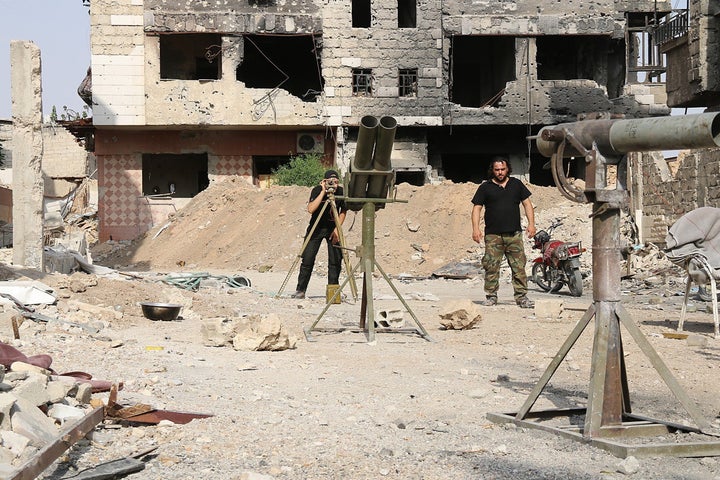 Members of Free Syrian Army of Syrian opposition make preparations before they stage an operation on Assad's regime forces in Damascus, Syria on August 2, 2015.