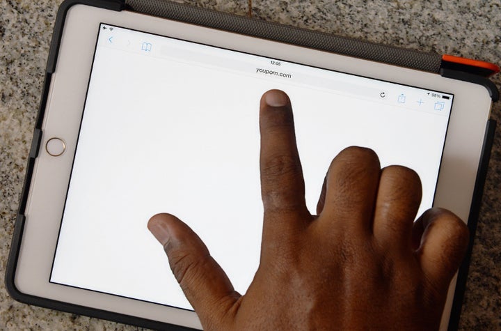 <span> An Indian internet user points out at a porn site showing a blank screen after being blocked by the internet serv