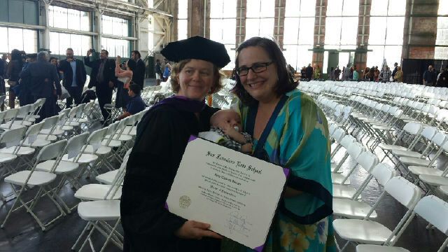 Mary Skinner at her law school graduation, with spouse Janeen and son Salo.