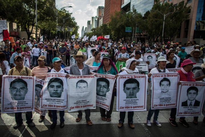 Demonstrators and relatives of the 43 missing students of Ayotzinapa college march during a protest rally ten months after the students disappearance on July 26, 2015 in Mexico City. 