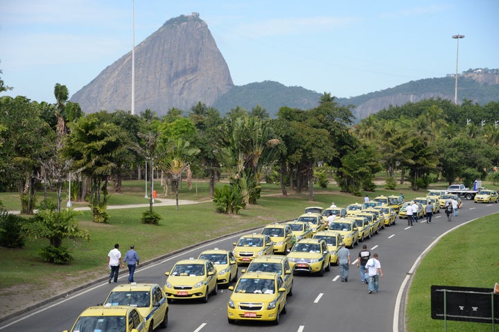 Hundreds of taxi drivers from Rio de Janeiro, Sao Paulo and Belo Horizonte block the avenue which links South and Center Rio de Janeiro on July 24, 2015, to protest against UBER, a mobile phone application to hail taxi.