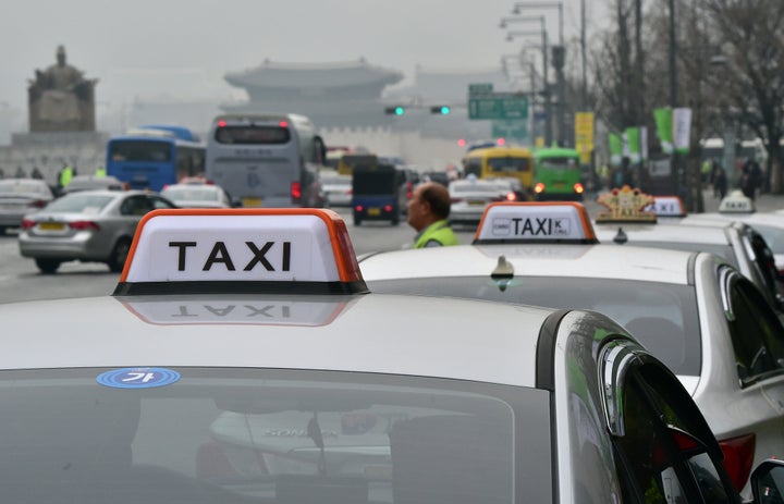 Taxis queue for passengers in downtown Seoul on March 31, 2015. South Korea's top mobile messenger operator launched a new web-based cab-hailing service to compete with California-based Uber, whose service has been subjected to crackdowns from state regulators.