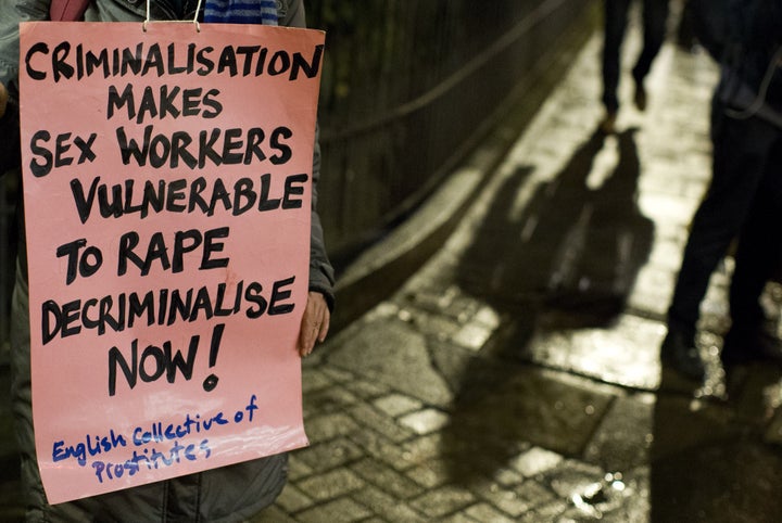 A protester holds a placard on the international day to end violence against sex workers, organized by the English Collective of Prostitutes.