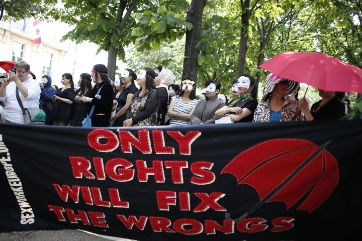 Sex workers take part in a June 2015 demonstration in Paris to celebrate the 40th anniversary of the Lyon Saint-Nizier church occupation by prostitutes and to denounce a bill that would criminalize buying sex.