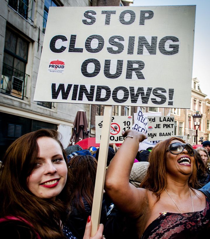 Sex workers and supporters demonstrate in April 2015 against closing window brothels in Amsterdam's red light district.