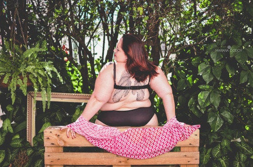 Foto de Fat woman in underwear or lingerie trying dresses at home.  Beautiful lady preparing for trip, journey or voyage. Woman posing with  luggage or suitcase. do Stock