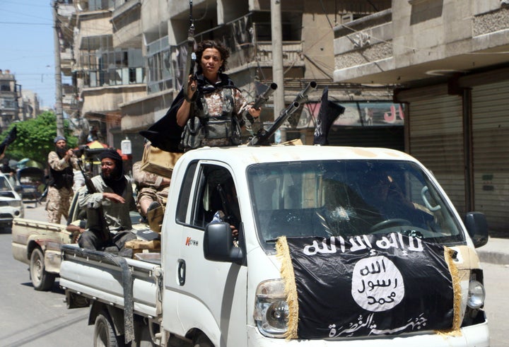 Fighters from Al-Qaeda's Syrian affiliate Al-Nusra Front drive in armed vehicles in the northern Syrian city of Aleppo as they head to a frontline, May 26, 2015.