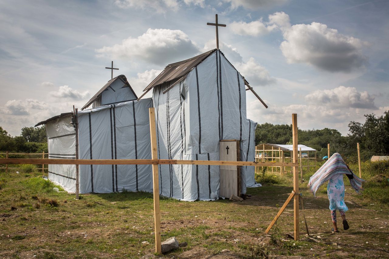 A woman enters the site of a church in a makeshift camp near the port of Calais on July 31, 2015.