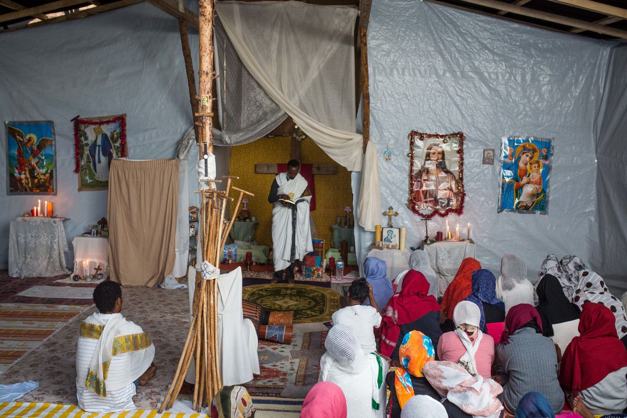 Kibrom Kasta leads an Orthodox service for Ethiopian and Eritrean worshippers at a church in a makeshift camp near the port of Calais on Aug. 2, 2015.