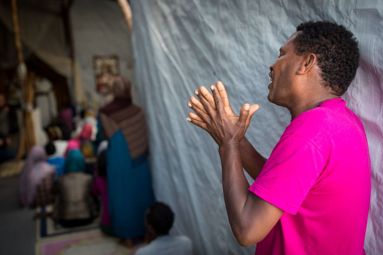 A man sings during an Orthodox service for Ethiopian and Eritrean worshippers at a church in a makeshift camp near the port of Calais on Aug. 2, 2015.