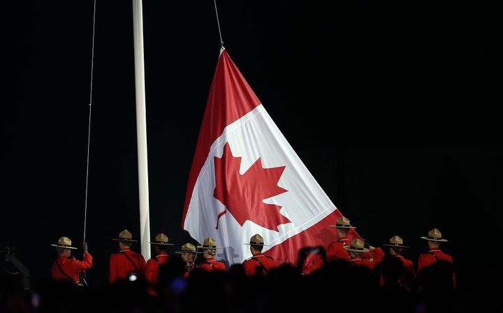 Royal Canadian Mounted Police lower the Canadian flag during the closing ceremonies of the 2015 Toronto Pan Am Games at Rogers Centre in Toronto, July 26, 2015. 