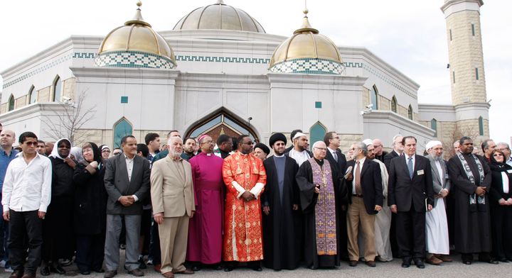 An interfaith group rallies at the Islamic Center of America to show unity and condemn the planned Good Friday protest by Pastor Terry Jones at the mosque April 21, 2011 in Dearborn, Michigan. Jones burned a copy of the Koran, the religious text of Islam, the previous month. 