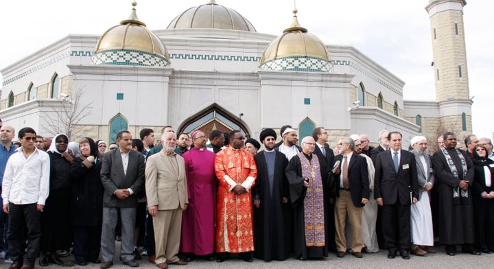 An interfaith group rallies at the Islamic Center of America to show unity and condemn the planned Good Friday protest by Pastor Terry Jones at the mosque April 21, 2011 in Dearborn, Michigan. Jones burned a copy of the Koran, the religious text of Islam, the previous month. 