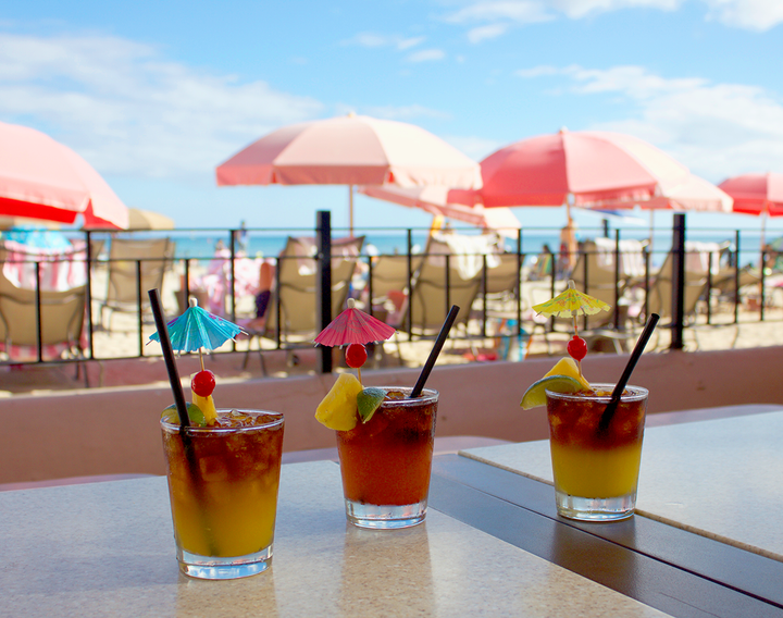 The Scratch Mai Tai, the Royal Mai Tai and the Mai Tai Degeneres at The Royal Hawaiian's Mai Tai Bar, looking over Waikiki Beach.