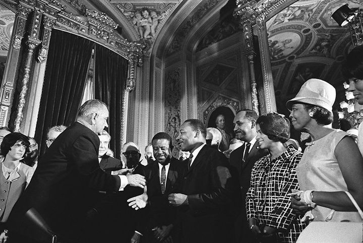 President Lyndon B. Johnson and the Rev. Martin Luther King Jr. shake hands at the signing of the Voting Rights Act of 1965.