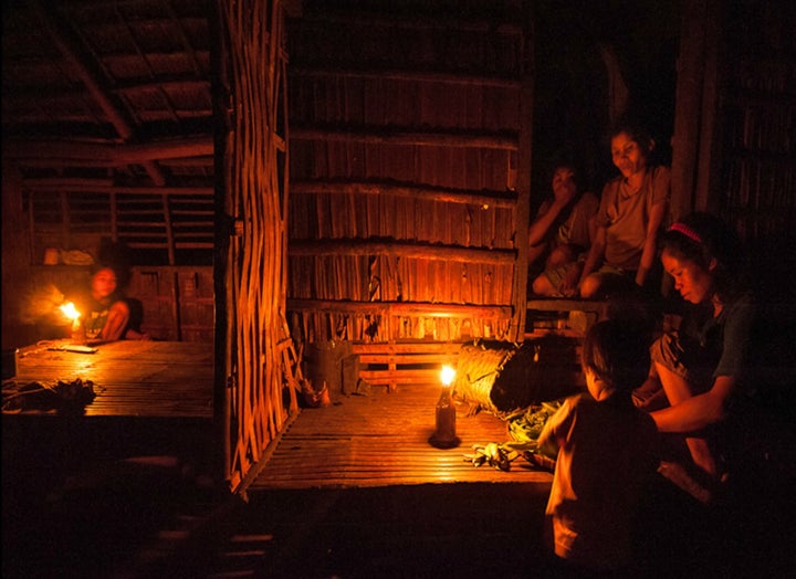 A family using a kerosene lamp