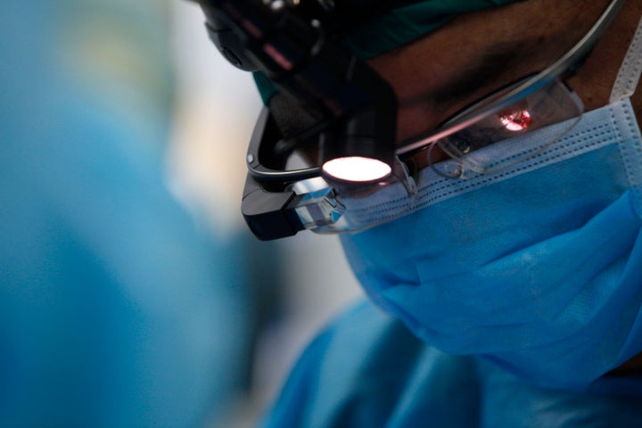 Doctor Huang Yunchao wears Google Glass while performing a live surgery to remove a tumor at The Third Affiliated Hospital of Kunming Medical University, also known as the Tumor Hospital of Yunnan Province, on November 27, 2014 in Kunming, China. 