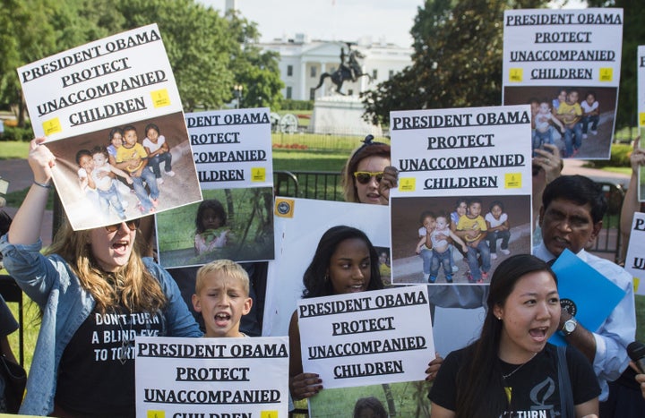 Demonstrators with Amnesty International and We Belong Together protest during a rally in Washington, D.C., on July 17, 2014.