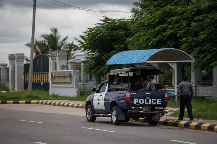 Police wait outside the USDP headquarters in Naypyitaw, Burma, on Aug. 13, 2015.