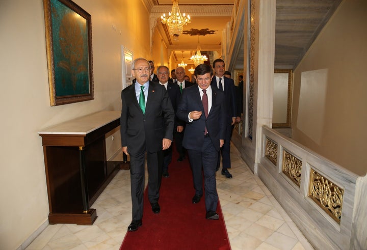 <p>Turkish Prime Minister and leader of AKP Ahmet Davutoglu, right, and CHP leader Kemal Kilicdaroglu walk together at the Ankara Palas Hotel in Turkey on Aug. 13, 2015.</p>