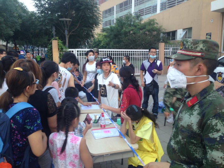 Volunteers work in Tianjin in the aftermath of massive explosions.